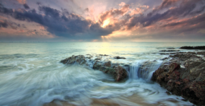 Wispy seawater over rocks